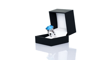 Cushion cut blue topaz Jewel or gems ring in dark blue jewel box. Collection of natural gemstones accessories. Studio shot