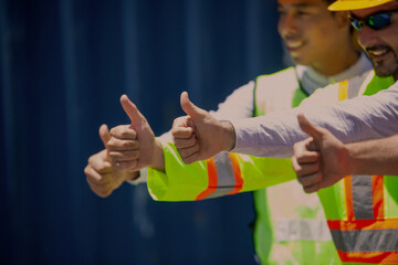 Group of workers and engineers with workers giving thumbs up in factory. Successful diverse teamwork standing in workplace.