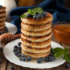 fresh pancakes blueberries and honey