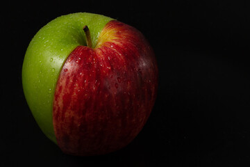 Half green apple and half red apple.