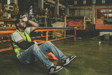 African American male worker with right arm injury wears cast can't work has to take sick leave for medical treatment : Male workers insured against work accidents that occur in factories.