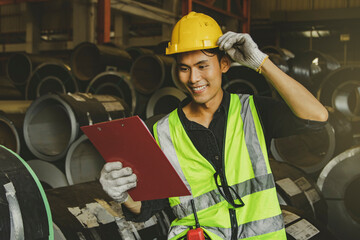 Happy professional industrial engineer Asian male worker wearing uniform and helmet steel plant...