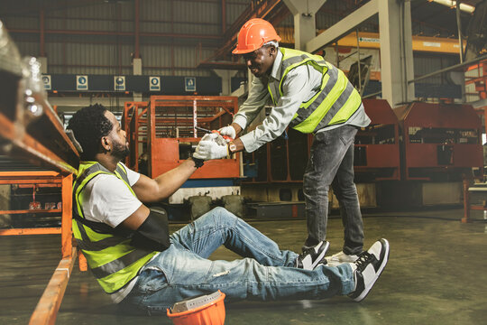 Friendship and sympathy for workers injured during work concept : Male african american worker injured in arm wearing cast sits in pain gets sympathy for help to take sick leave to heal. - Powered by Adobe