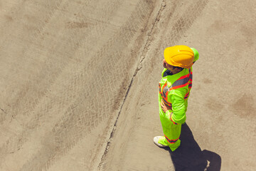 Top view portrait of two workers standing on concrete floor of construction site and planning project, copy space background
