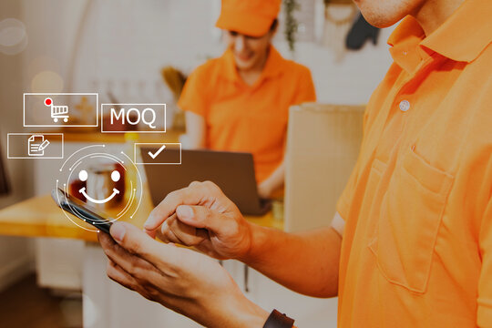 Male delivery worker uses smartphone to take orders from customers online to prepare the boxes, with female colleague cheering on the service : Technology icons, and online orders.