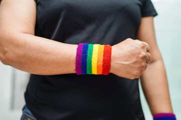 Fototapeta premium Asian woman with rainbow flag, LGBT symbol rights and gender equality, LGBT Pride Month in June.