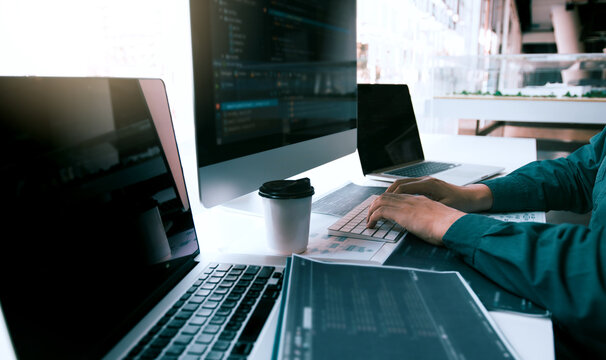 Asian man working code program developer computer web development working design software on desk in office.
