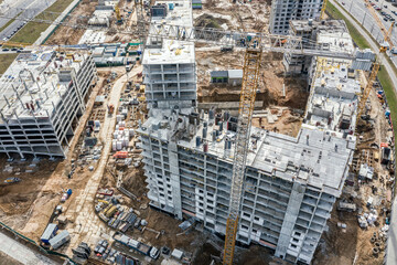 crane at construction site near residential complex. aerial photo of busy construction site.