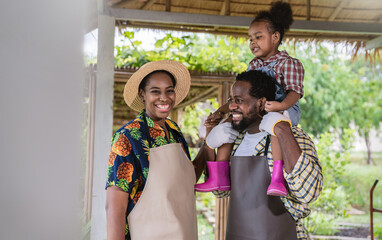 Portrait of happy sme owner black African American farmer family working in barn farm, worker planting in organic nersery, startup small business owner, lifestyle mother father farmer job concept
