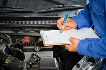Auto mechanic holding clipboard checklist the car at mechanic shop, Mockup blank clipboard,...