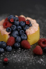 Cake with cream covered with juicy berries.