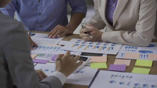 small group of young people at a business meeting a team in a modern office planning of work design and brainstorming ideas Hands of a businessman working on documents and laptops Video 4k