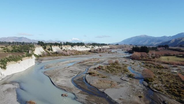 2.7K Aerial footage of Awatere River with white cliffs and snowy mountain Part4