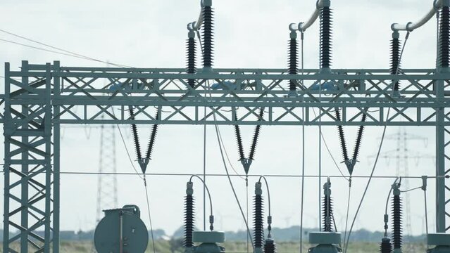 A close-up shot of an electrical power plant. Slow-motion, pan right
