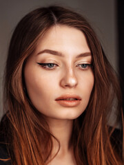 Obraz premium beautiful sad woman with dark hair and healthy clean skin, looked down. Youth and beauty concept