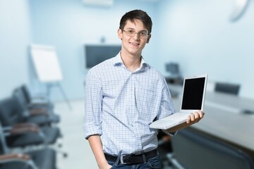 Optimistic male student or worker using laptop pc