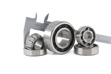 Group of roller bearings and caliper over white