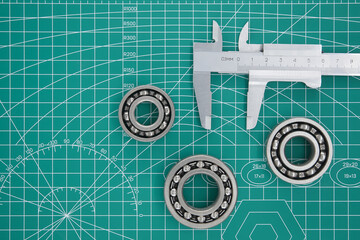 Measure caliper and roller bearings on cutting mat