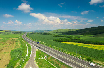Fototapeta na wymiar Aerial view over a highway in Romania that connects Sibiu with Alba-Iulia cities in Transylvania. Roads of Romania. Transportation industry.