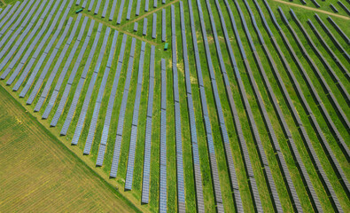 Aerial texture view with a big solar panel plant on top of the hills. Summer industrial landscape with a plant that produce electricity from the sunlight. Green eco energy industry.