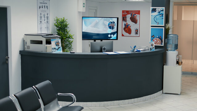 No People In Empty Waiting Area At Clinical Center With Reception Desk, Waiting Room With Seats To Start Checkup Visit Appointment. Medical Examination With Doctor At Hospital Lobby.