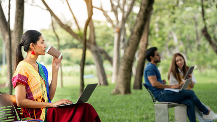 Diverse LGBTQ Gay transexual Study Outdoors at Park. Young Student at the outdoor. Working Outside. Fiends student sitting at park for collective work with notebooks and Smart Phone and Drink Coffee