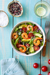 Salad with shrimps, avocado, tomatoes, onions and seeds. Healthy eating. Diet.