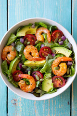 Salad with shrimps, avocado, tomatoes, onions and seeds. Healthy eating. Diet.