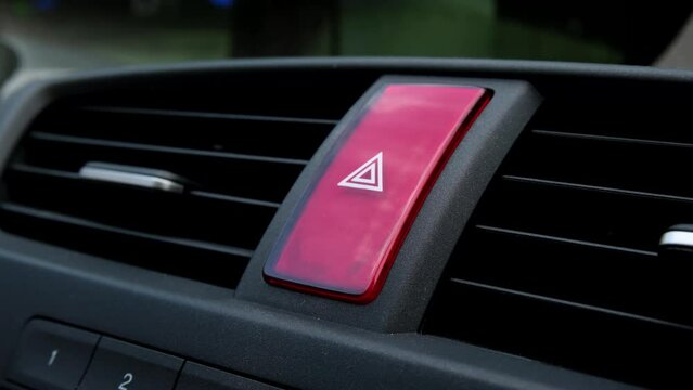 A man's hand presses the red emergency stop button in a car. 4K footage