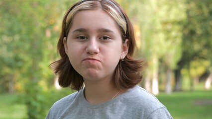 a teenage girl with an Asian appearance chews up leftovers and laughs with crumbs from her mouth....