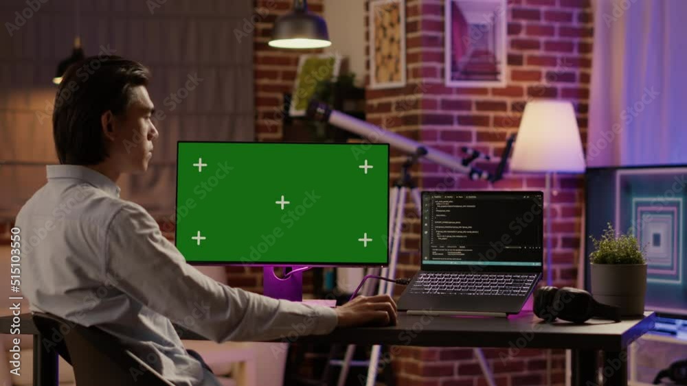 Poster office employee analyzing greenscreen on computer monitor at home desk. using blank chroma key templ