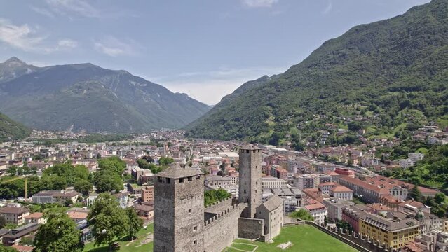 Aerial view of City of Bellinzona, Canton Ticino, with Unesco world heritage castle Castelgrande on a sunny summer day. Movie shot  July 4th, 2022, Bellinzona, Switzerland.