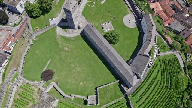 Aerial view of City of Bellinzona, Canton Ticino, with Unesco world heritage castle Castelgrande on a sunny summer day. Movie shot July 4th, 2022, Bellinzona, Switzerland.