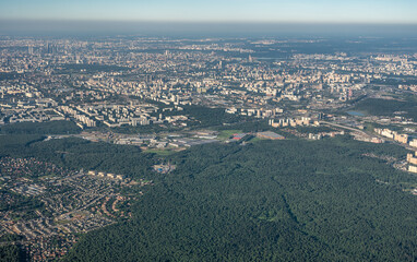 Aerial view photo from airplane of city and clear sky. aerial photo of large city from an airplane window. view of city of Moscow through window from plane