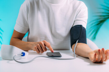 Fototapeta premium Measuring Blood Pressure and Entering Health Data in a SmartPhone