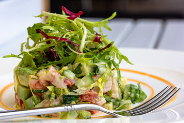 Layer Salad with Shrimps, Crab and Avocado in Luxury Restaurant