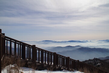 Beautiful winter mountain sea of clouds and wooden stairs