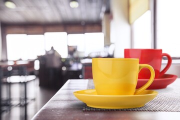 Ceramic cups of aromatic coffee with foam on the table in cafe