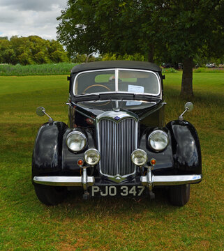 Classic Black  Riley RMA  Motor Car Parked on glass.