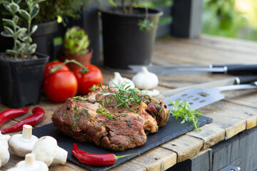 Marinated beef steak on wooden table top. Healthy food concept. Beef cut and spices for cooking bbq sauce outdoors, garden kitchen