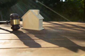 Real estate and protecting insurance concept - Invest to a family home. House model and judge gavel