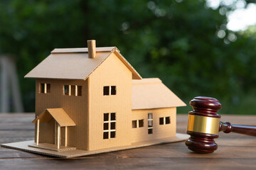 Real estate and protecting insurance concept - Invest to a family home. House model and judge gavel