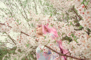 Portrait of young european woman wearing kimono. Asian beauty. Cherry blossoms. Hanami. Sightseeing...