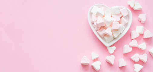 Fototapeta premium Heart-shaped marshmallows on a pink background