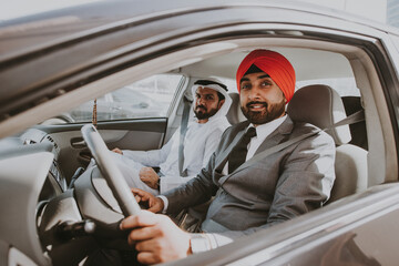 Two friends and business colleagues driving together in Dubai after work