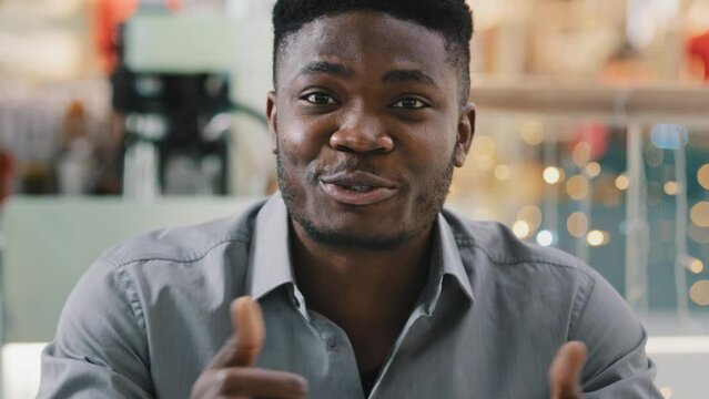 Webcam view close-up happy male blogger talking to camera young confident businessman filming motivational video communicate in online conference advertises recommends showing gesture of appreciation