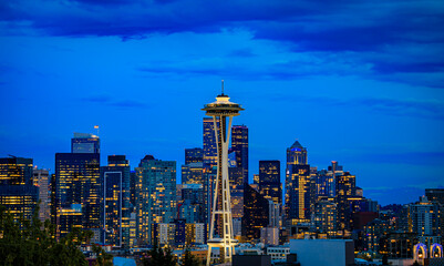 City skyline view with the Space Needle and Mount Rainier at sunset in Seattle