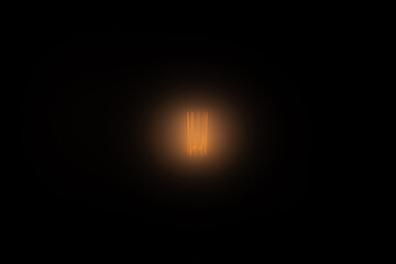 soft warm glow of the lamp on a dark background