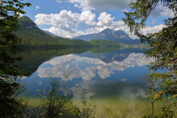 Fototapeta premium Reflections on the lake Altaussee viewed from the shore, Bad Aussee, Salzkammergut, Styria, Austria, Europe, with the Dachstein mountains in the background
