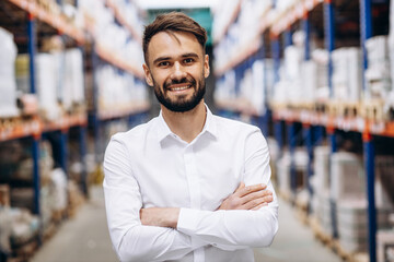 Portrait of business man standing at factory in white shirt